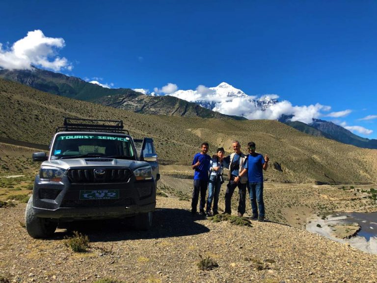 3 People Posing For A Photo In Front Of A Jeep In Upper Mustang 768x576